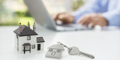 Searching the internet for real estate or new house with model home and key